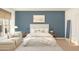Relaxing bedroom featuring a queen-size bed, soft lighting, chaise lounge, and decorative pillows at 7646 W Park St, Laveen, AZ 85339