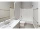 Bright bathroom featuring a white vanity, toilet, and a bathtub with shower at 7730 E Boise St, Mesa, AZ 85207