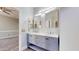 Bathroom with double vanity, gray cabinets, marble counters, next to the bedroom at 7730 E Boise St, Mesa, AZ 85207