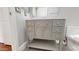 Bathroom showcasing a gray vanity with many drawers, a white countertop and flooring at 7730 E Boise St, Mesa, AZ 85207