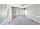 Bedroom with neutral carpet, modern fan, and nice natural light from the arched windows at 7730 E Boise St, Mesa, AZ 85207