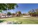 View of the community pool and grassy volleyball court, highlighting recreational amenities at 7730 E Boise St, Mesa, AZ 85207