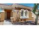 Charming home with a distinctive stucco exterior, terracotta roof, and arched window detail at 7730 E Boise St, Mesa, AZ 85207