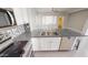 Open kitchen features granite countertops, stainless steel appliances, and a modern design at 7730 E Boise St, Mesa, AZ 85207