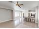 Open-concept living room with modern lighting, tile flooring, and kitchen bar at 7730 E Boise St, Mesa, AZ 85207