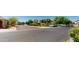 A charming neighborhood street view features well-maintained homes and lush landscaping on a sunny day at 7730 E Boise St, Mesa, AZ 85207