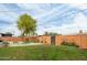 Large backyard featuring grass, gravel, planters, and a block wall for privacy at 8626 E Windsor Ave, Scottsdale, AZ 85257