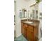 Bathroom featuring a wood vanity with a granite countertop, neutral wall color, and a large mirror at 8626 E Windsor Ave, Scottsdale, AZ 85257