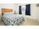 Cozy bedroom features a wooden headboard, natural light from window, and neutral-toned carpet at 8626 E Windsor Ave, Scottsdale, AZ 85257