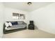 Minimalist bedroom with a daybed, accent chair, and neutral carpet creating a relaxing space at 8626 E Windsor Ave, Scottsdale, AZ 85257