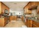 Spacious kitchen with wooden cabinets, granite countertops, and stainless steel appliances at 8626 E Windsor Ave, Scottsdale, AZ 85257
