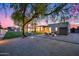 Expansive backyard featuring a modern patio with a fire pit, lush lawn, mature trees, and a sparkling pool at 12809 N 67Th St, Scottsdale, AZ 85254