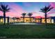 Beautiful backyard with a refreshing pool, palm trees, and a spacious green lawn, ideal for recreation at 12809 N 67Th St, Scottsdale, AZ 85254