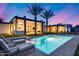 Relaxing backyard with a sparkling pool, lounge chairs, and palm trees, perfect for outdoor enjoyment at 12809 N 67Th St, Scottsdale, AZ 85254