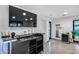 Modern bar area with a TV, sink, wine racks, and ample counter space for serving and entertaining at 12809 N 67Th St, Scottsdale, AZ 85254