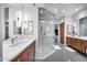 Bright bathroom showcasing a spacious glass shower, dual sinks, and contemporary design at 12809 N 67Th St, Scottsdale, AZ 85254