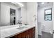 Stylish bathroom with wood vanity, quartz countertop, and modern fixtures at 12809 N 67Th St, Scottsdale, AZ 85254