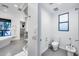 Well-lit bathroom featuring a bidet, modern toilet, large window, and access to the shower at 12809 N 67Th St, Scottsdale, AZ 85254