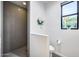 Modern bathroom featuring a walk-in shower and a window at 12809 N 67Th St, Scottsdale, AZ 85254
