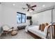 Modern bedroom with TV, ceiling fan, and a window at 12809 N 67Th St, Scottsdale, AZ 85254