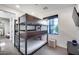 Bedroom with a modern triple bunk bed and a view to the exterior at 12809 N 67Th St, Scottsdale, AZ 85254