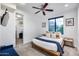 Cozy bedroom featuring a bed, ceiling fan, and closet at 12809 N 67Th St, Scottsdale, AZ 85254
