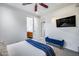 Bright bedroom showing a bed, tv, and ensuite bathroom at 12809 N 67Th St, Scottsdale, AZ 85254