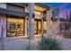 Stylish modern home entryway with desert foliage and warm, inviting lighting at 12809 N 67Th St, Scottsdale, AZ 85254