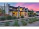 Stylish house featuring desert plants, sleek lines, and a well-lit entryway at 12809 N 67Th St, Scottsdale, AZ 85254