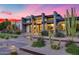 Contemporary home featuring desert landscaping, walkways, and mature cactus with a captivating pink sunset at 12809 N 67Th St, Scottsdale, AZ 85254