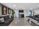 Stylish game room with a comfortable sofa, pool table, and vibrant horse portraits at 12809 N 67Th St, Scottsdale, AZ 85254
