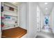 Hallway nook features a built-in bench with storage and bookshelf at 12809 N 67Th St, Scottsdale, AZ 85254