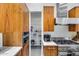 A modern kitchen featuring wooden cabinets, stainless steel appliances, and a walk-in pantry at 12809 N 67Th St, Scottsdale, AZ 85254