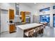 Bright kitchen featuring stainless appliances, wood cabinetry, and large central island with bar stool seating at 12809 N 67Th St, Scottsdale, AZ 85254