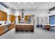 Spacious kitchen with stainless steel appliances, a large island with seating, and a stylish dining area at 12809 N 67Th St, Scottsdale, AZ 85254