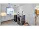Well-lit laundry room equipped with modern washer, dryer, sink, and ample cabinet space at 12809 N 67Th St, Scottsdale, AZ 85254