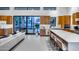 Open-concept living space with a kitchen island, white sofa, and large sliding glass doors to the patio at 12809 N 67Th St, Scottsdale, AZ 85254