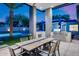 Well-equipped outdoor kitchen and dining area, complete with a built-in grill, sink, and seating overlooking the pool at 12809 N 67Th St, Scottsdale, AZ 85254