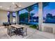 Outdoor dining and kitchen space with a view of the pool, lounge chairs, and landscaped backyard at 12809 N 67Th St, Scottsdale, AZ 85254