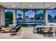 Inviting outdoor living area with a covered patio, comfortable seating, dining table, and a serene pool view at 12809 N 67Th St, Scottsdale, AZ 85254
