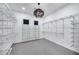 Spacious walk-in closet with custom shelving and a stylish chandelier at 12809 N 67Th St, Scottsdale, AZ 85254