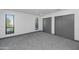 Spacious bedroom with natural light, plush carpeting, and ample closet space at 15028 N 9Th St, Phoenix, AZ 85022