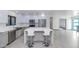 Contemporary kitchen boasting white cabinetry, stainless steel appliances, and island seating at 15028 N 9Th St, Phoenix, AZ 85022