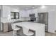 Modern kitchen boasts a large island with seating, stainless steel appliances, and open design at 15028 N 9Th St, Phoenix, AZ 85022