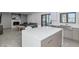 Modern kitchen with a large island extends to a living room and sliding glass doors to the outside at 15028 N 9Th St, Phoenix, AZ 85022