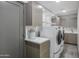 Functional laundry room equipped with side-by-side washer and dryer and ample storage at 15028 N 9Th St, Phoenix, AZ 85022