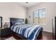 Bedroom features a bed with blue and white striped bedding and a window providing natural light at 15664 W Vernon Ave, Goodyear, AZ 85395