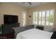 This bedroom offers plantation shutters, ceiling fan, and stylish furniture at 15664 W Vernon Ave, Goodyear, AZ 85395