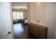 View of the primary bedroom with a wood dresser, chair, and a king-size bed at 15664 W Vernon Ave, Goodyear, AZ 85395
