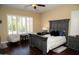 Bedroom boasts plantation shutters, a ceiling fan, and ample space for relaxation at 15664 W Vernon Ave, Goodyear, AZ 85395